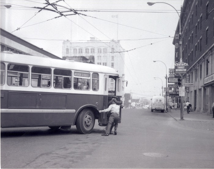 two men pushing a trolley around a corner onto Cumberland St