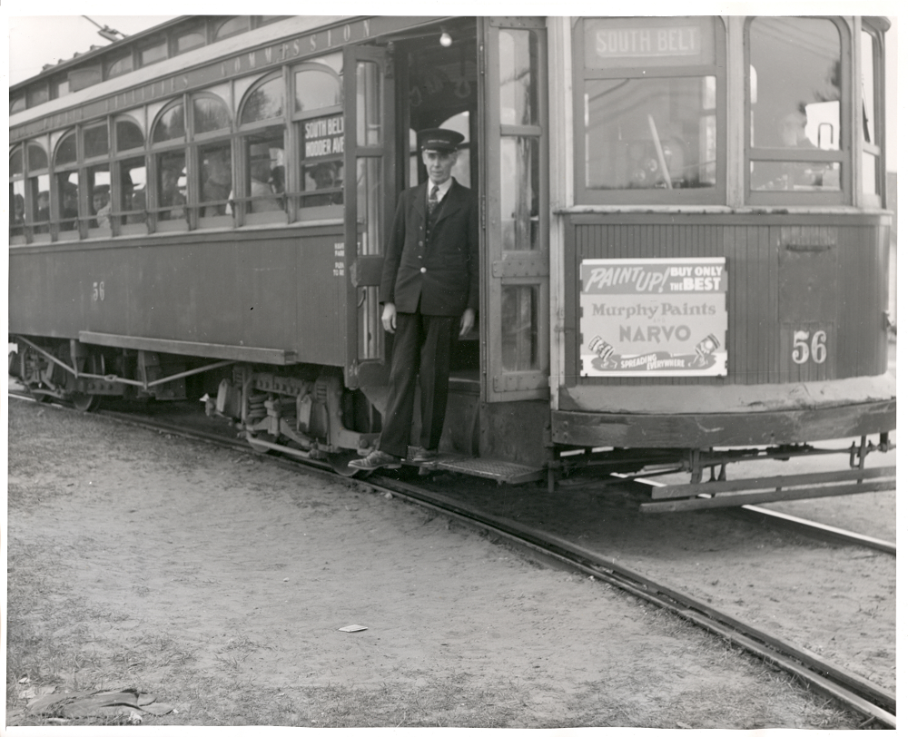 Street Railway employee stepping out of street railway car 
