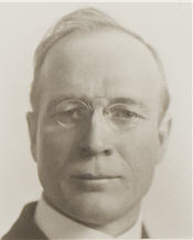 Mayor A. H. Dennis sitting for a black and white portrait wearing a suit