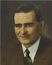 Mayor Albert Hinton wears a brown suit and black tie