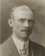 Mayor C. H. Jackson sitting for a black and white photo wearing a suit 