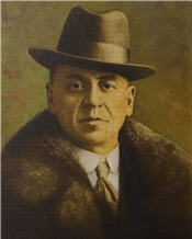 Mayor Blaquier sits wearing a fur trimmed suit and hat