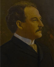 Mayor George Thomas Marks sitting showing a profile of his face wearing a suit 