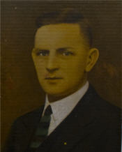 Mayor George Blanchard sits wearing a suit and checked tie