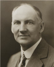 Mayor J. E. Crawford sitting wearing a suit