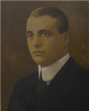 Mayor Carrick sits wearing a suit