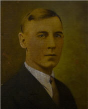 Mayor Percy Ibbertson sits wearing a suit and has blonde hair