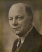 Mayor Pow sitting for his black and white photogrpah wearing a suit