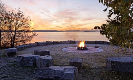 fire surrounded by rocks at sunset