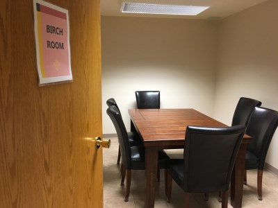 inside of the 55 Plus Centre Birch Room with a desk and chairs