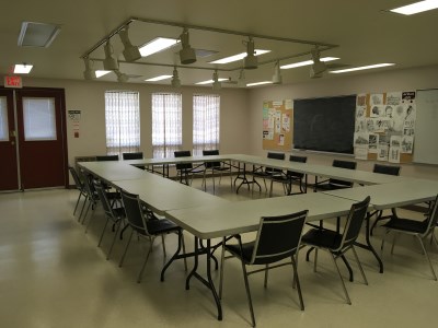 inside of the 55 Plus Centre Craft Room 1 with a square table and chairs