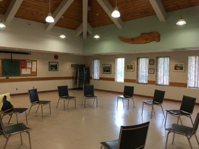 inside of the 55 Plus Centre Multipurpose Room with chairs in a cirle