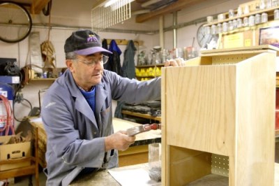 Man woodworking in the Fix-It Club at the 55 Plus Centre