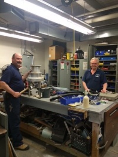 two maintenance workers in a shop