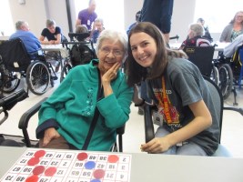 elderly woman and volunteer with bingo card
