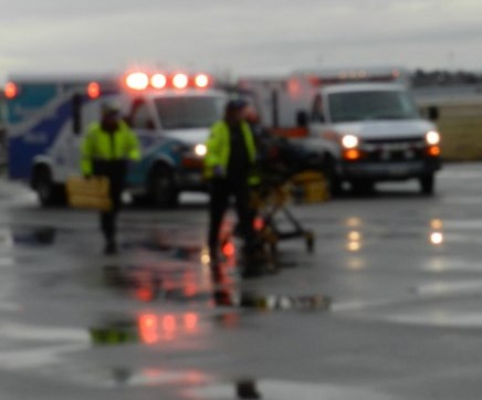 EMS crew in front of vehicles