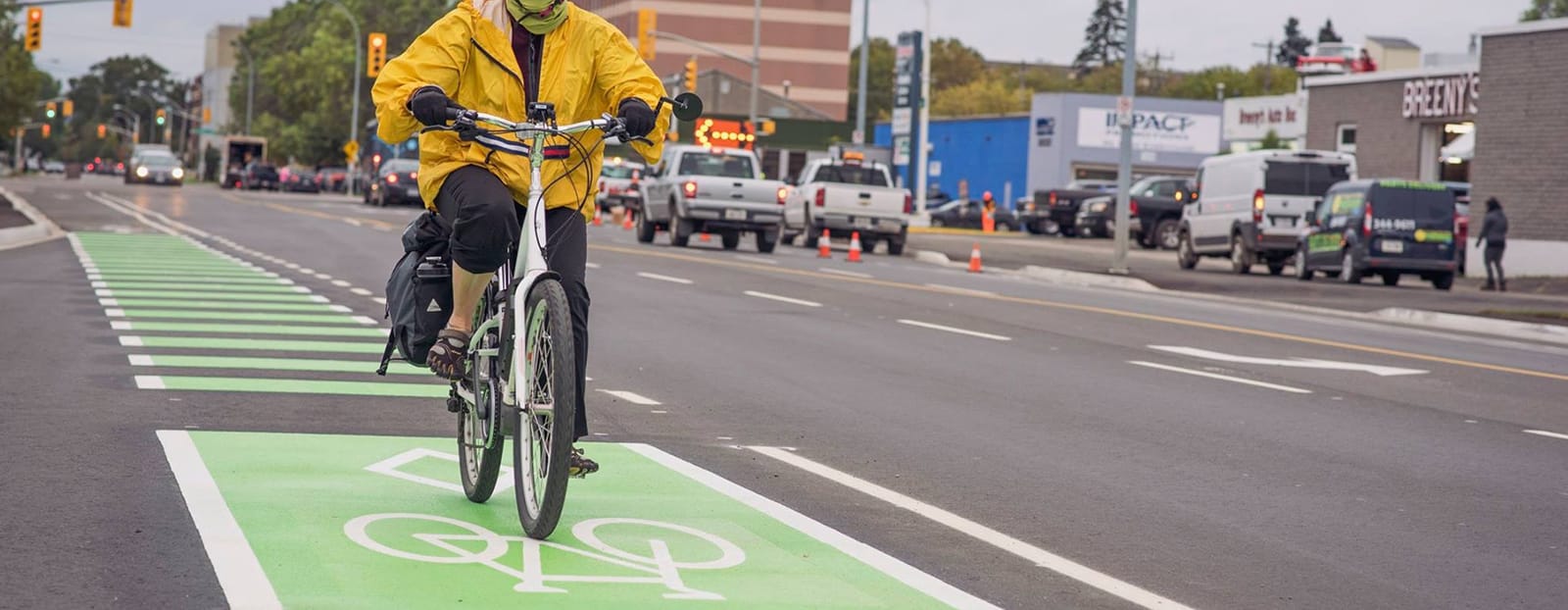 person riding bike in bike lane on road