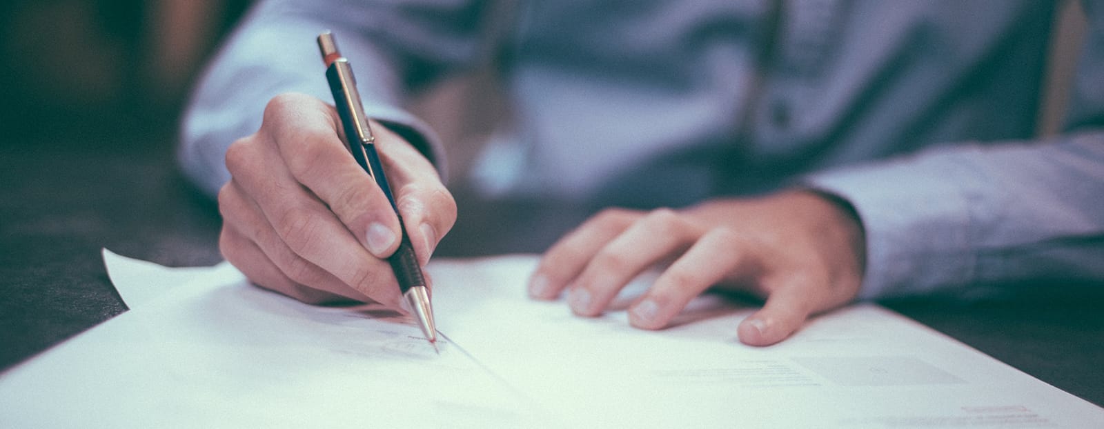 person filling out paper form