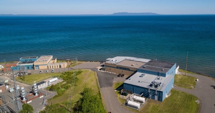 An aerial photo shows the Bare Point Water Treatment Plant, with Lake Superior and the Sleeping Giant in the background.