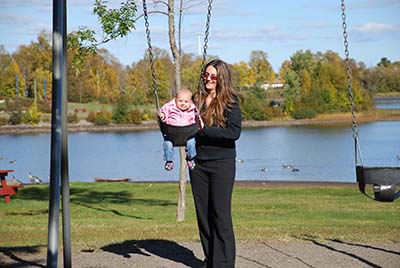 Baby being pushed in a swing at Boulevard Lake