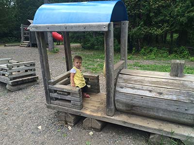 Girl on play structure at Centennial Park