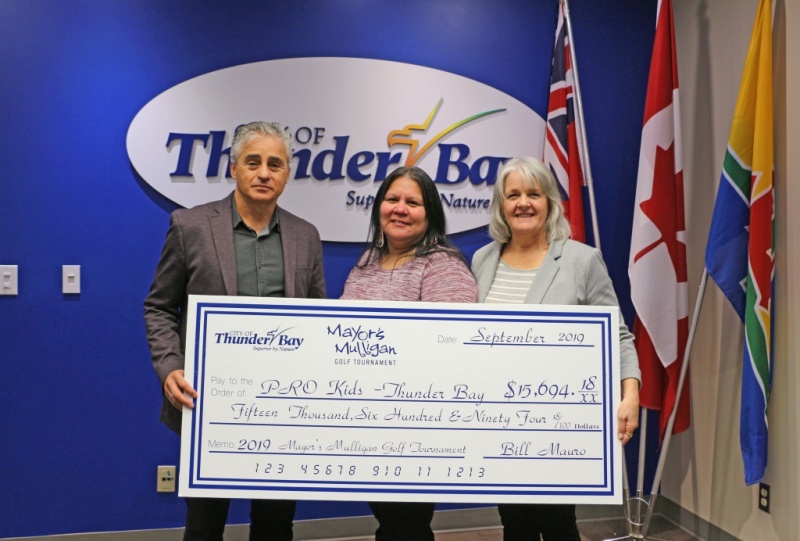 Mayor and two women holding a large cheque