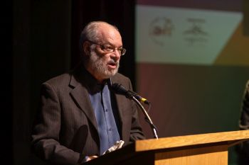 person at podium speaking and accepting award