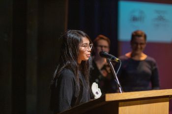 young person at podium speaking and accepting an award
