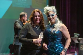 Drag queen presents award to woman on stage