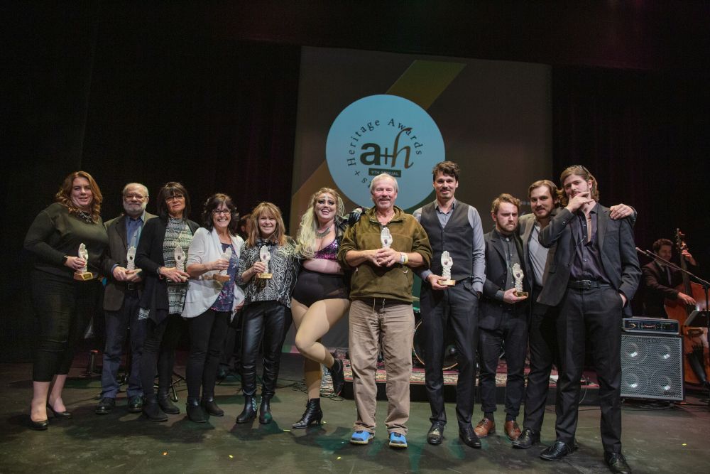 group of award winners standing on a stage