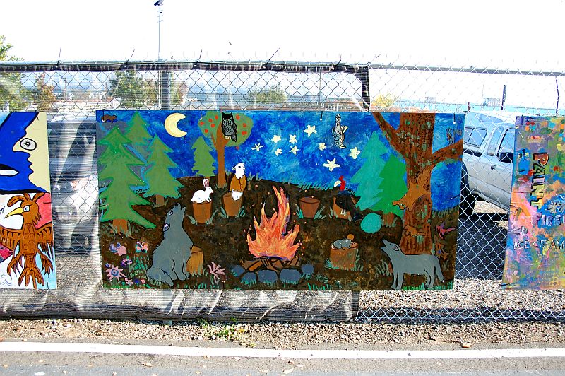 Mural on fence by baggage building