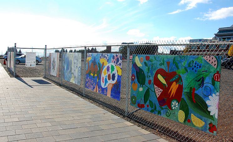 Mural on fence by baggage building