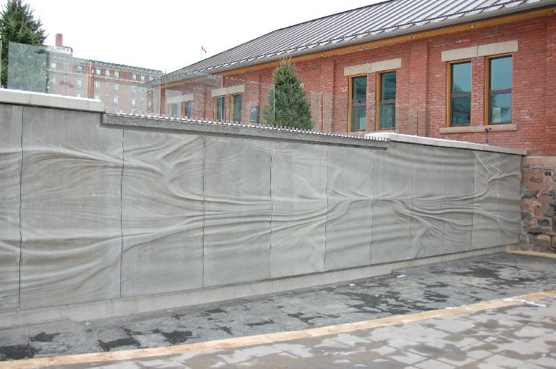 Embedded History sculpture near Baggage Building with a wave-like texture