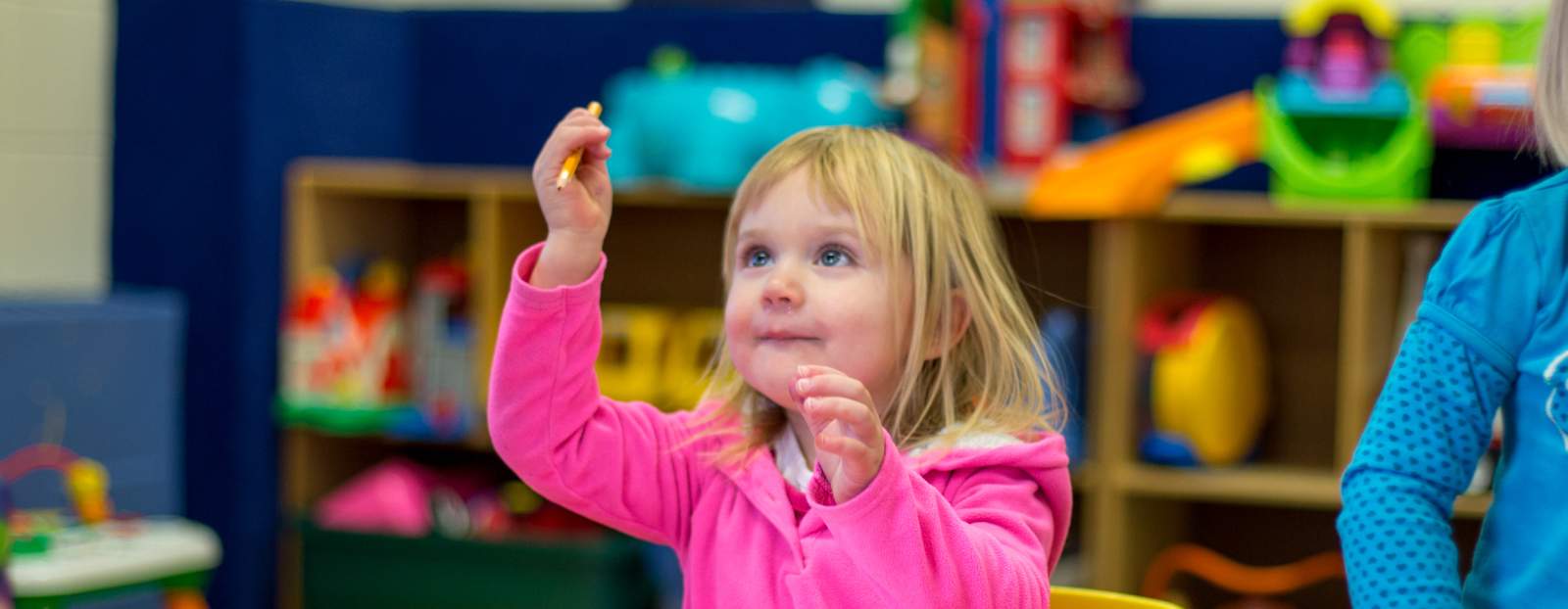 young girl holding a pencil