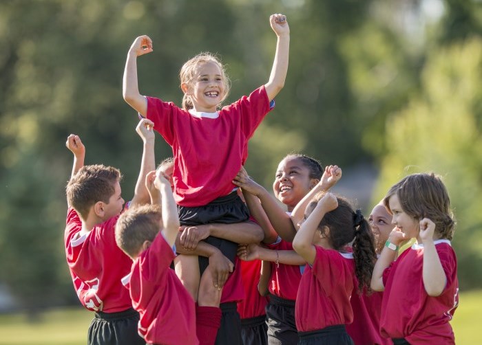 Children cheering after soccer game