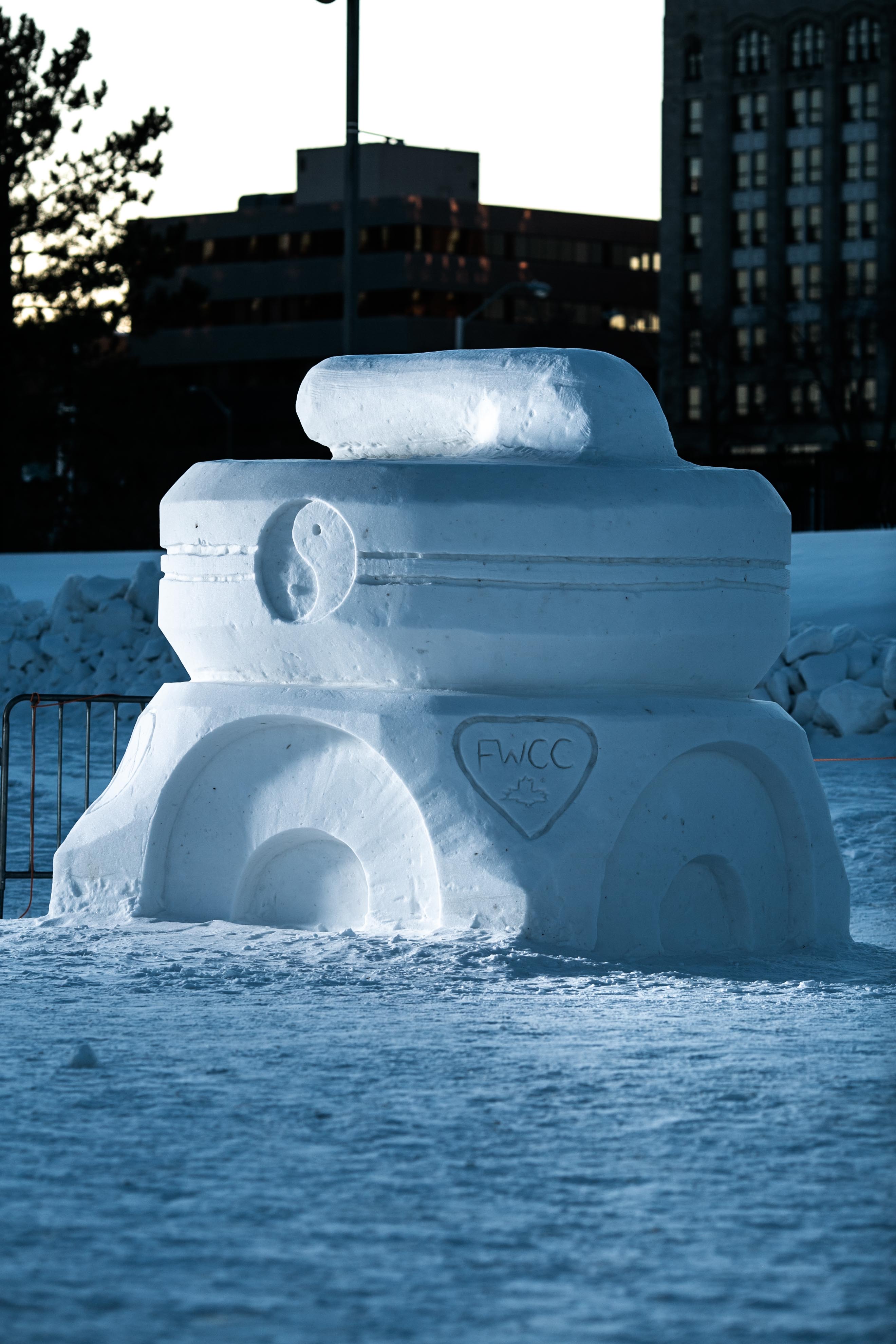 A snow sculpture of a large curling rock
