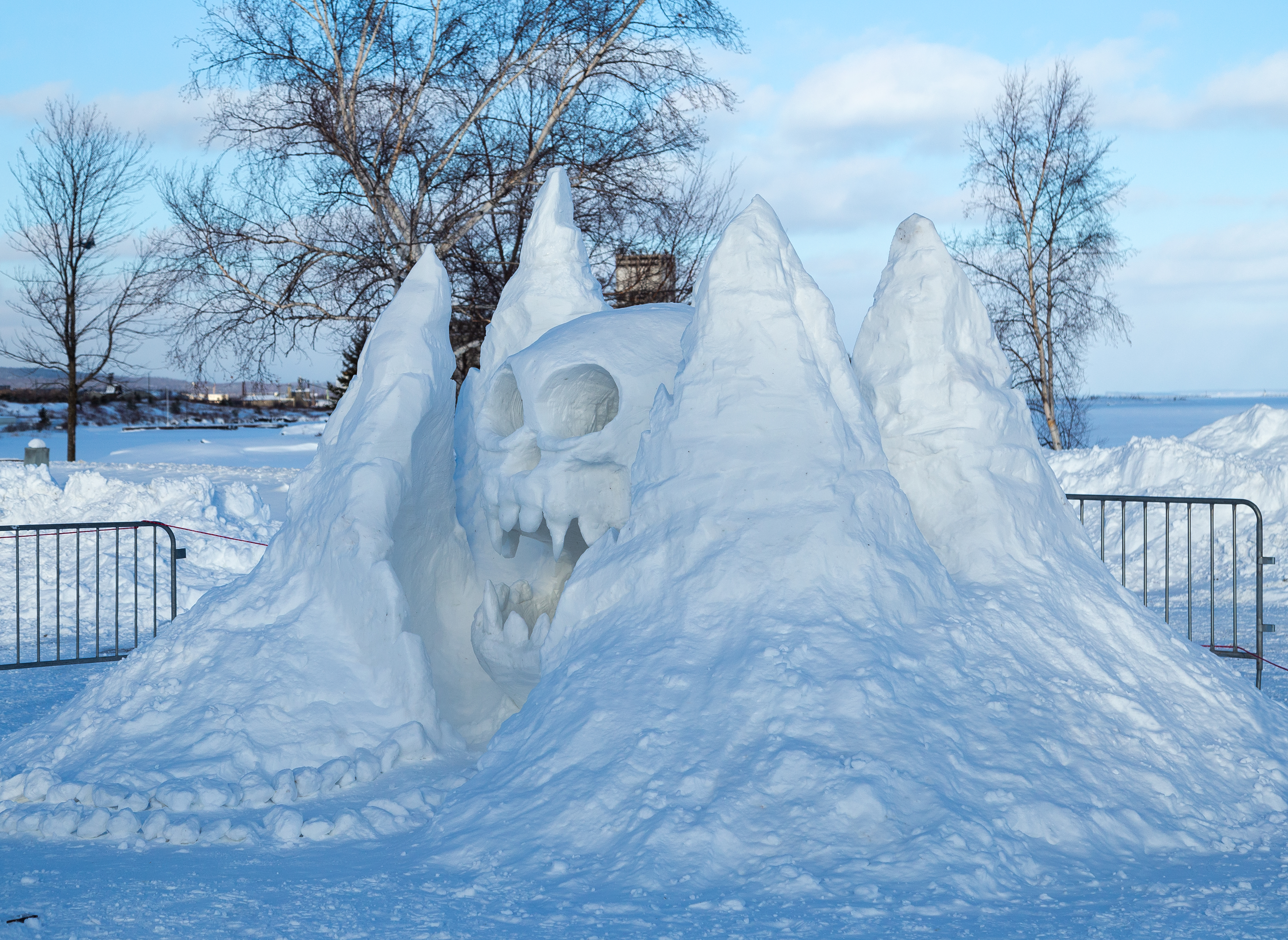 A snow sculpture of a skull as part of a mountain