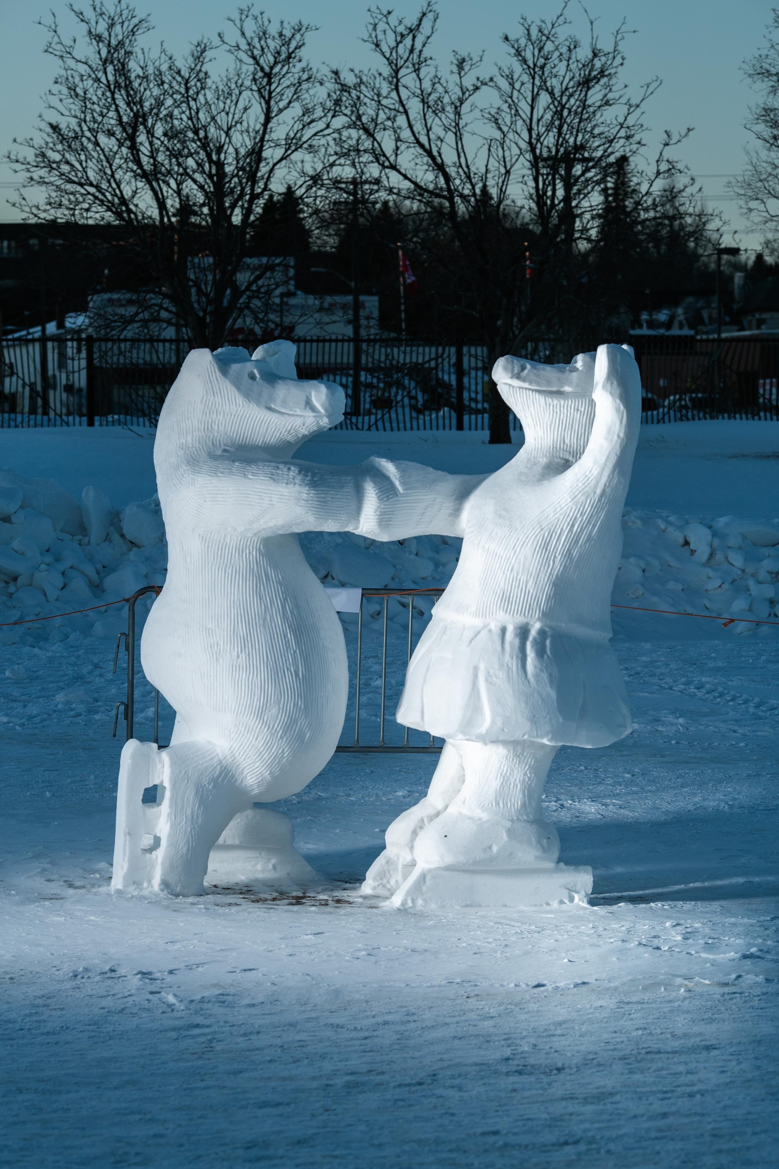 A snow sculpture of two bears skating together
