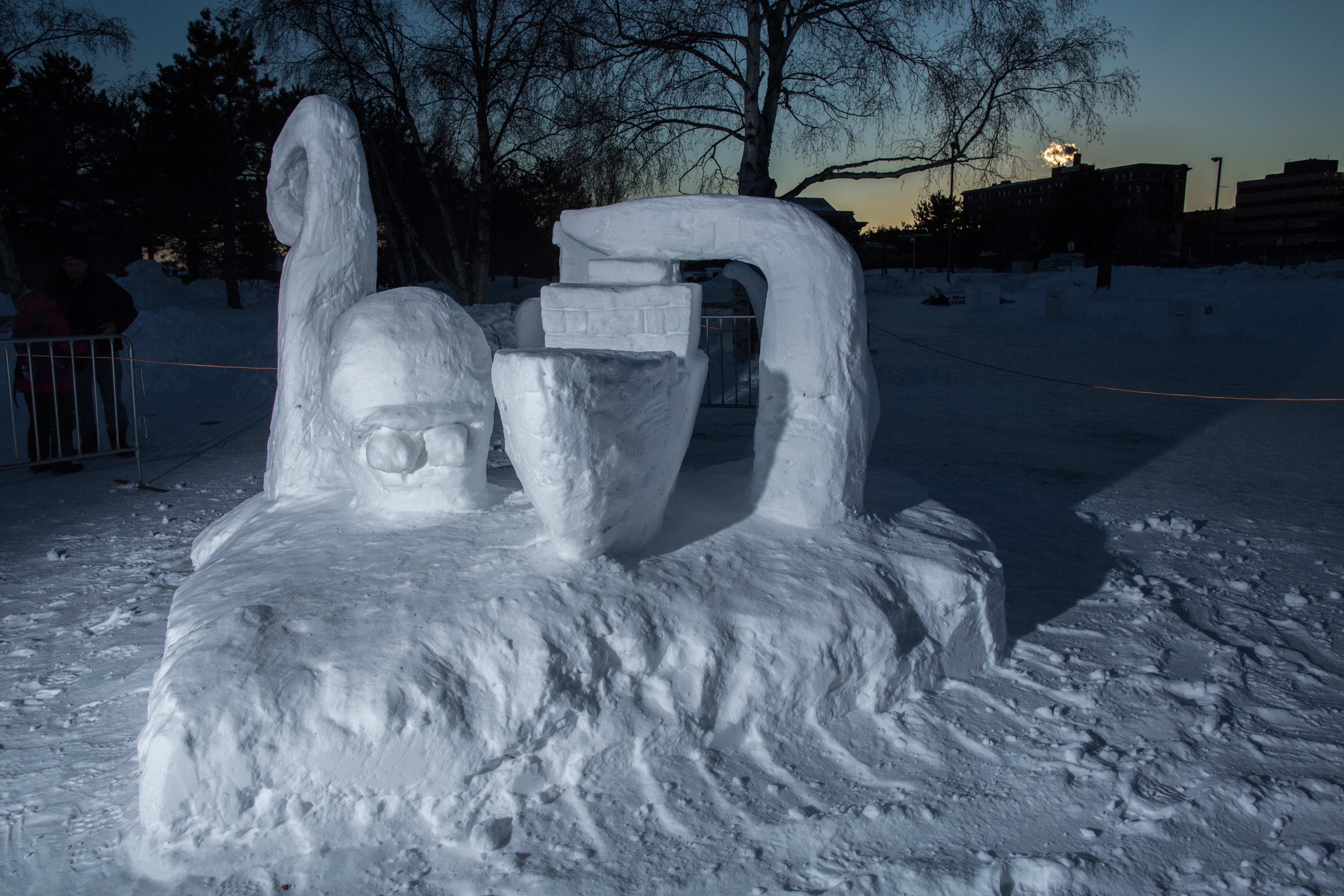 A snow sculpture of a mythical kraken creature and a ship