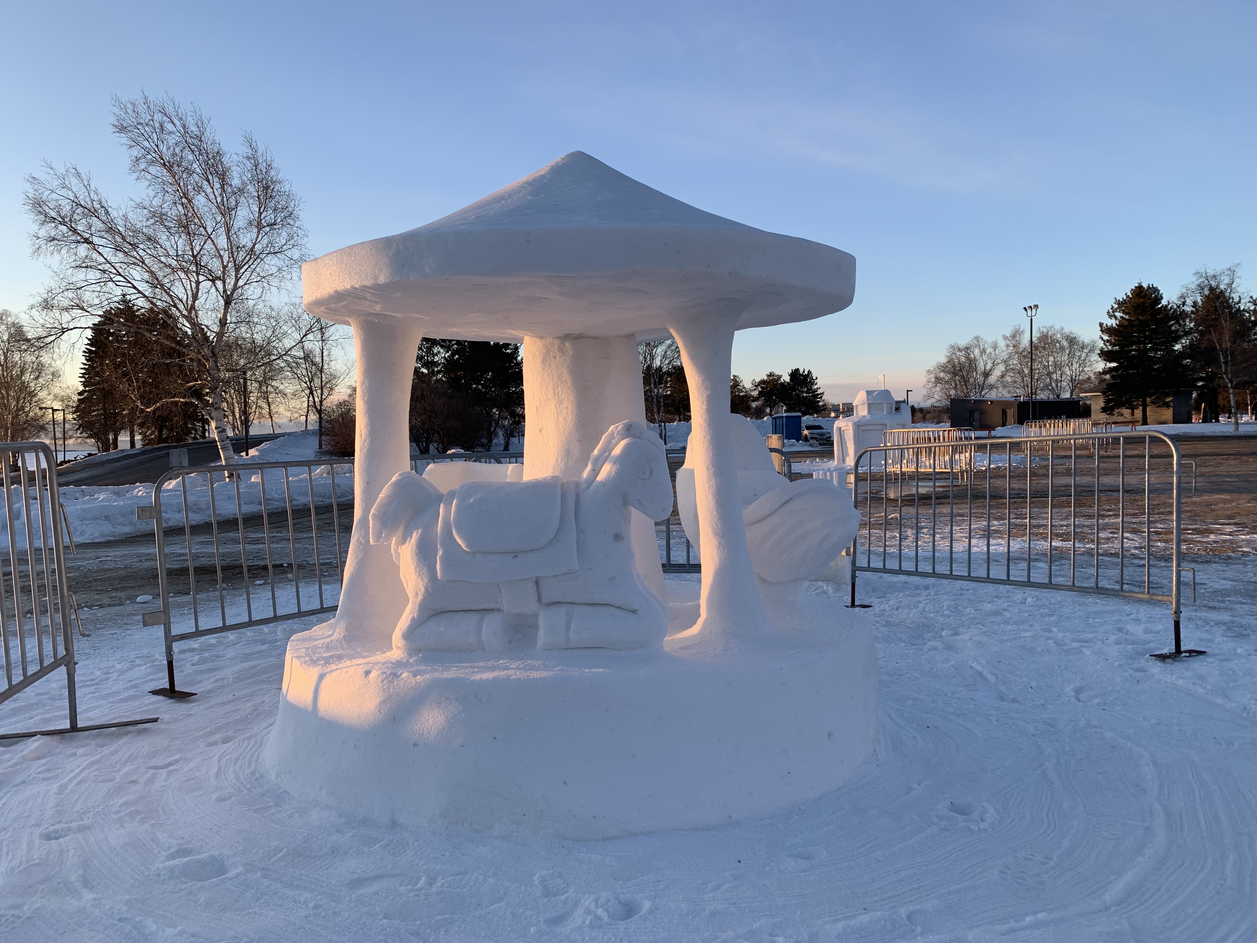 A snow sculpture of a coin carousel.