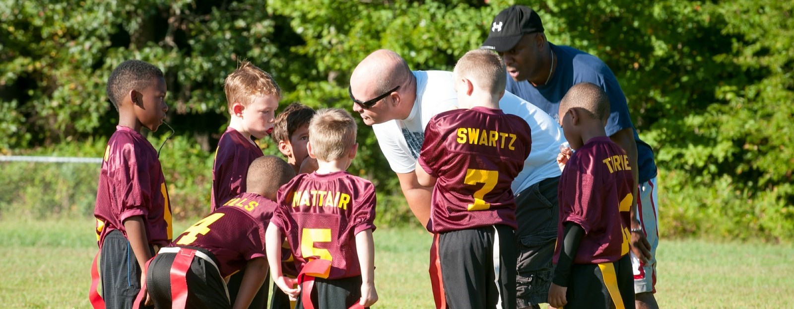 children in a huddle at soccer game