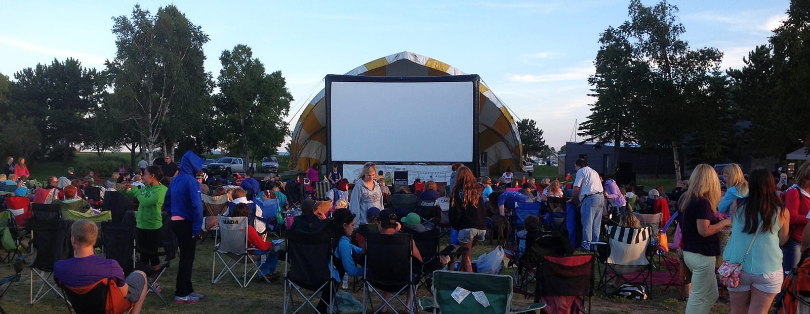 people in park watching outdoor movie