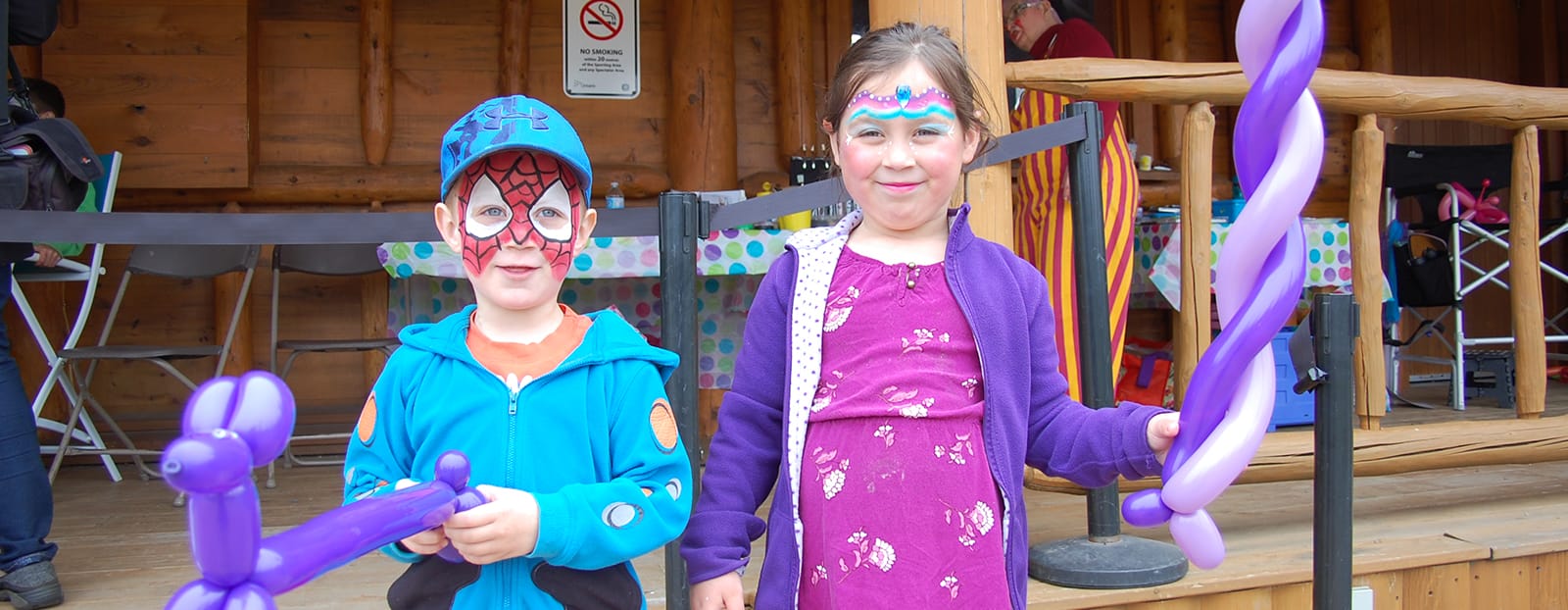 kids with painted faces and balloon animals
