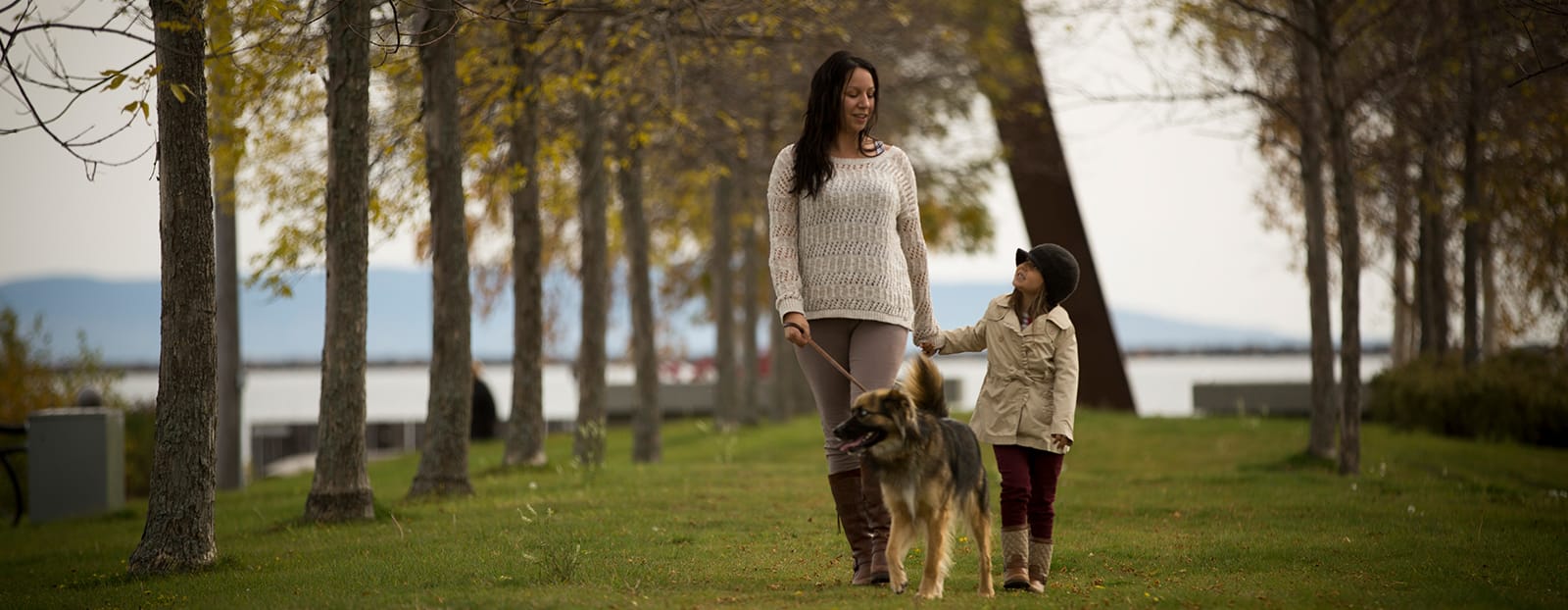 mother and daughter walking with their dog