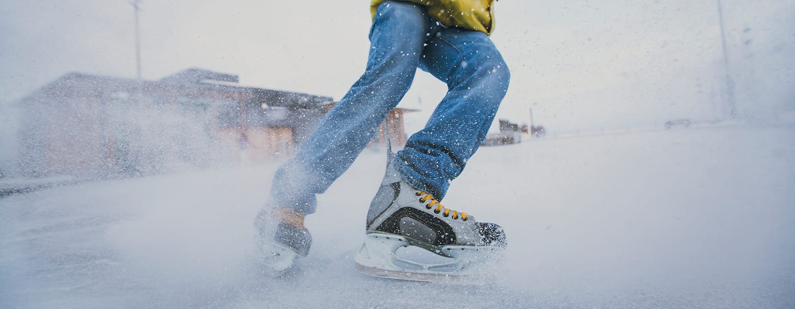 skater spraying snow at camera