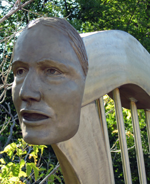 A photo of a bust of Catherin Vickers attached to a harp