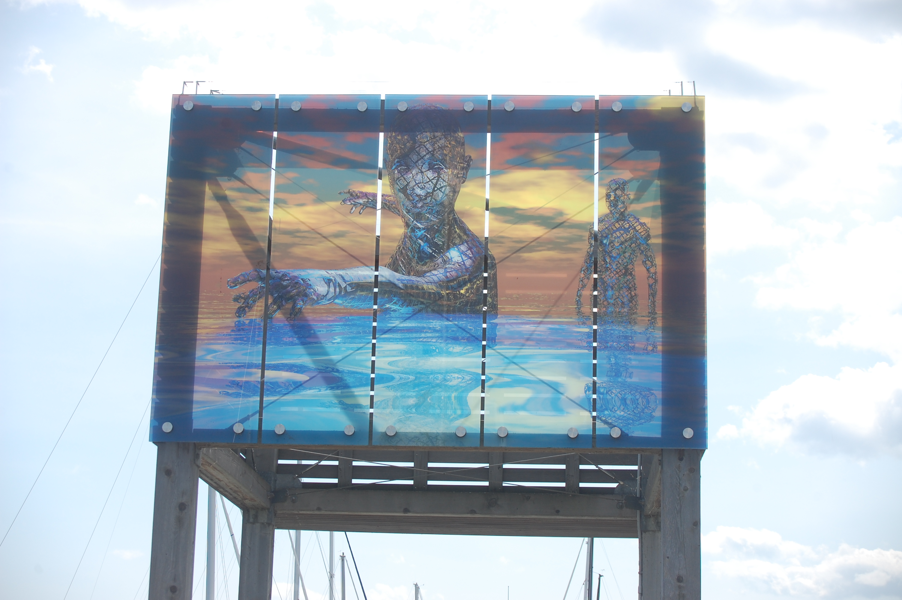A glass pane install of the artwork Swimmers
