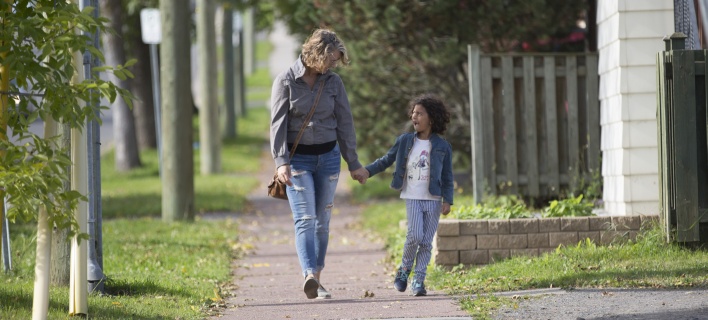 Child and Mother Walking down Street