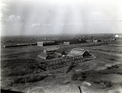 an aerial view of several buildings outside the city