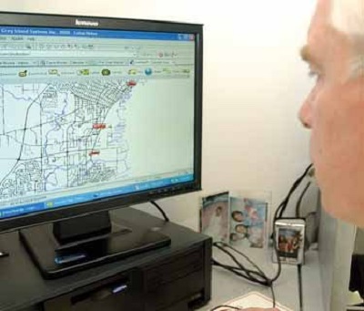a man looking at a computer screen with a map of Thunder Bay Transit routes pulled up